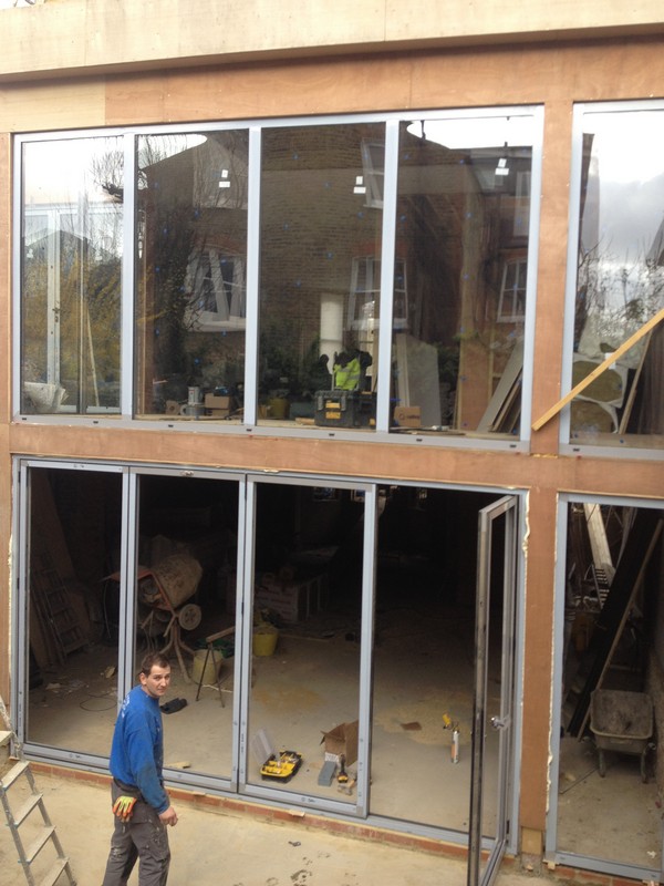 Aluminium bi-fold doors with two-storey glazing in Teddington
