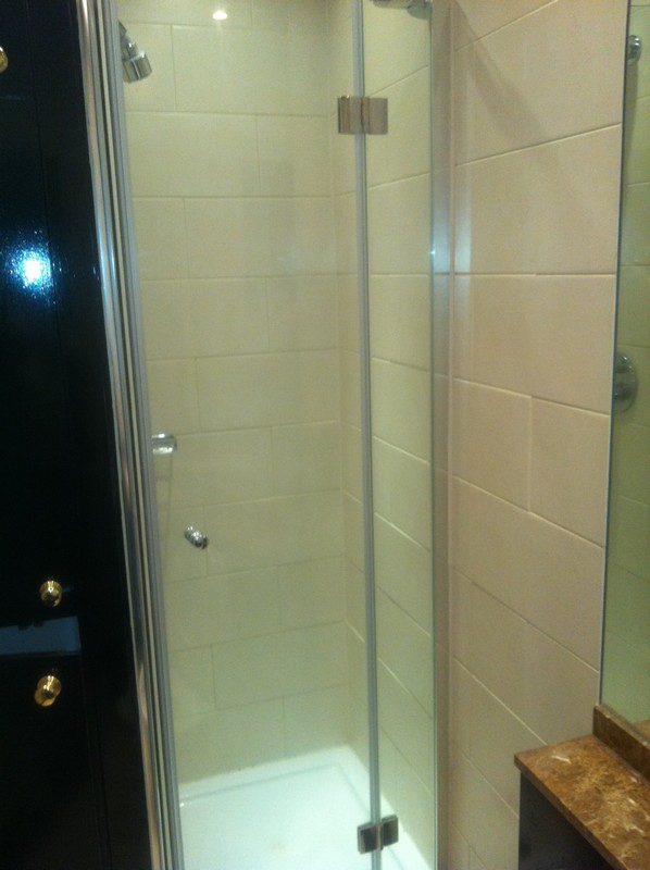 Frameless glass shower enclosure with chrome fittings in Teddington