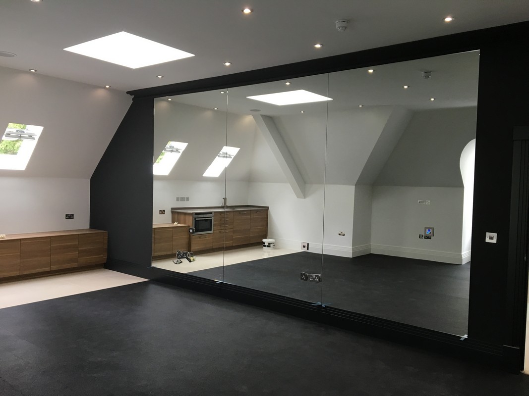 Frameless glass wall dividing loft conversion in Teddington