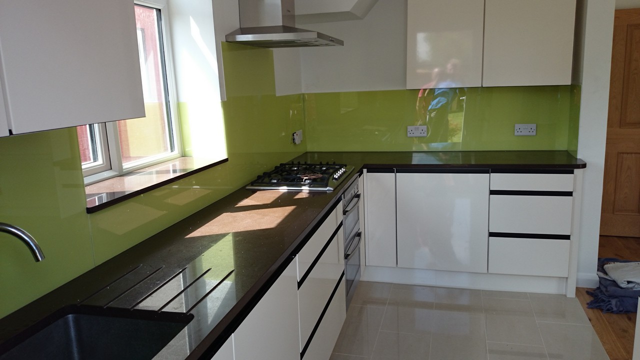 Lime green glass kitchen splashback installed by Teddington glaziers