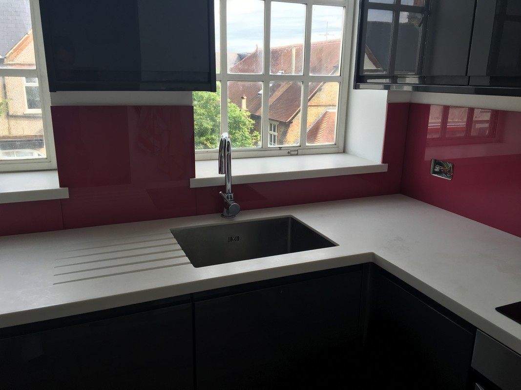 Deep plum coloured glass splashback in modern Teddington kitchen