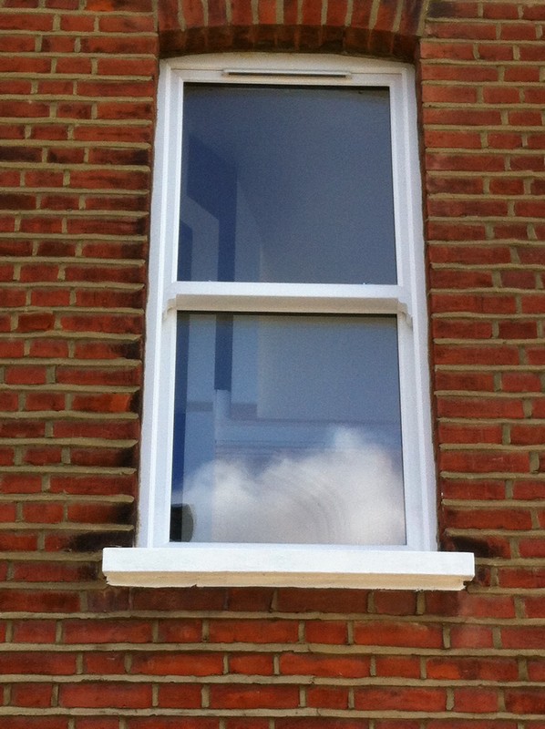 uPVC sash window on Victorian red brick house in Teddington